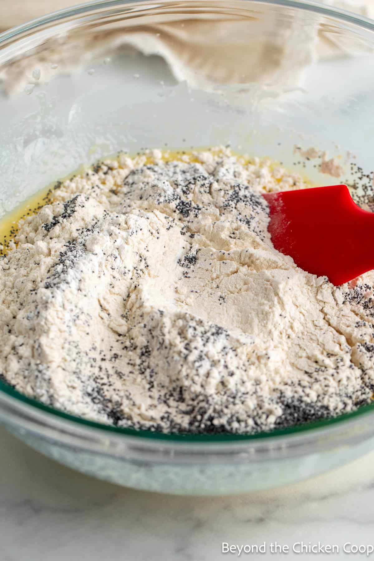 Mixing dry ingredients into wet ingredients for muffin batter. 