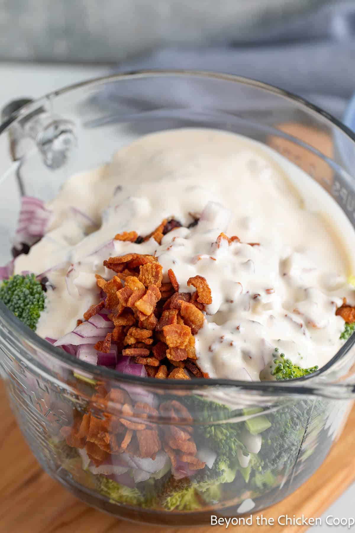 Dressing poured over the top of broccoli salad. 