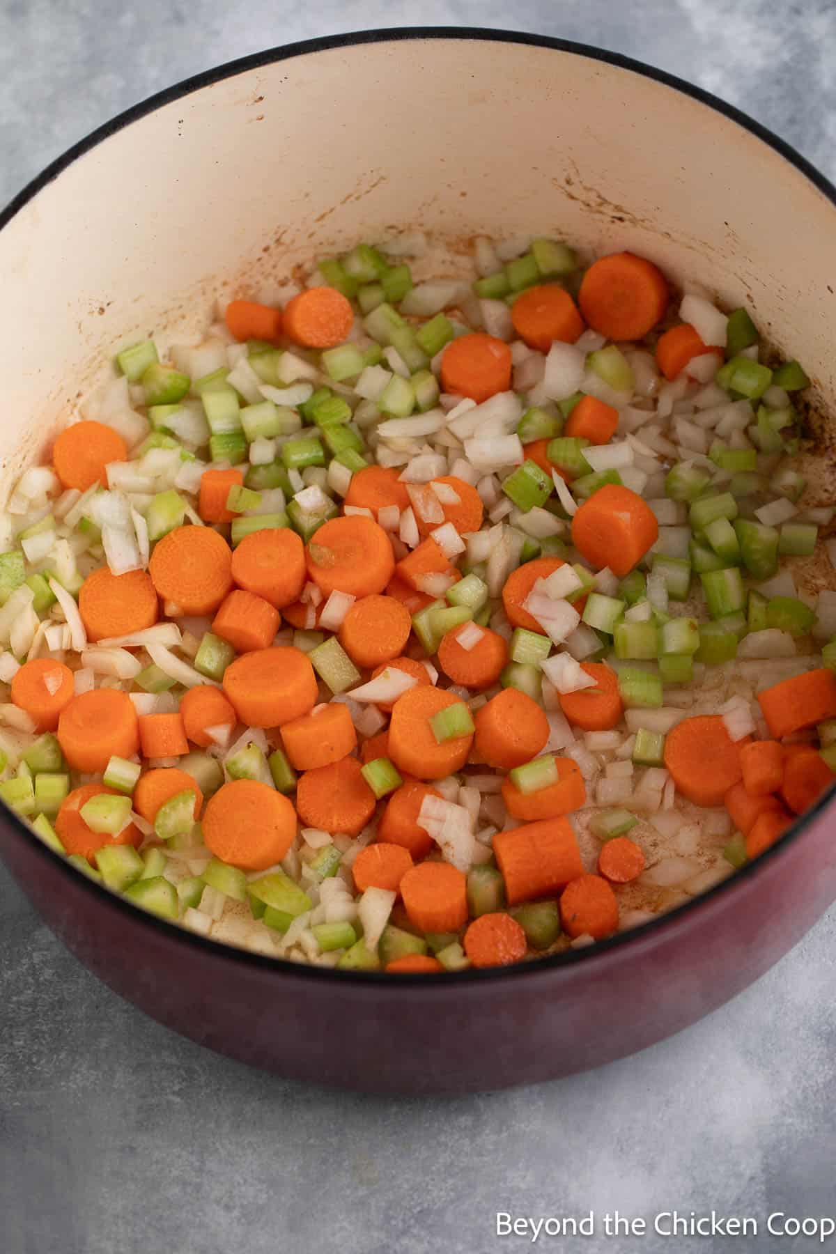Chopped carrots, onions and celery in a dutch oven. 