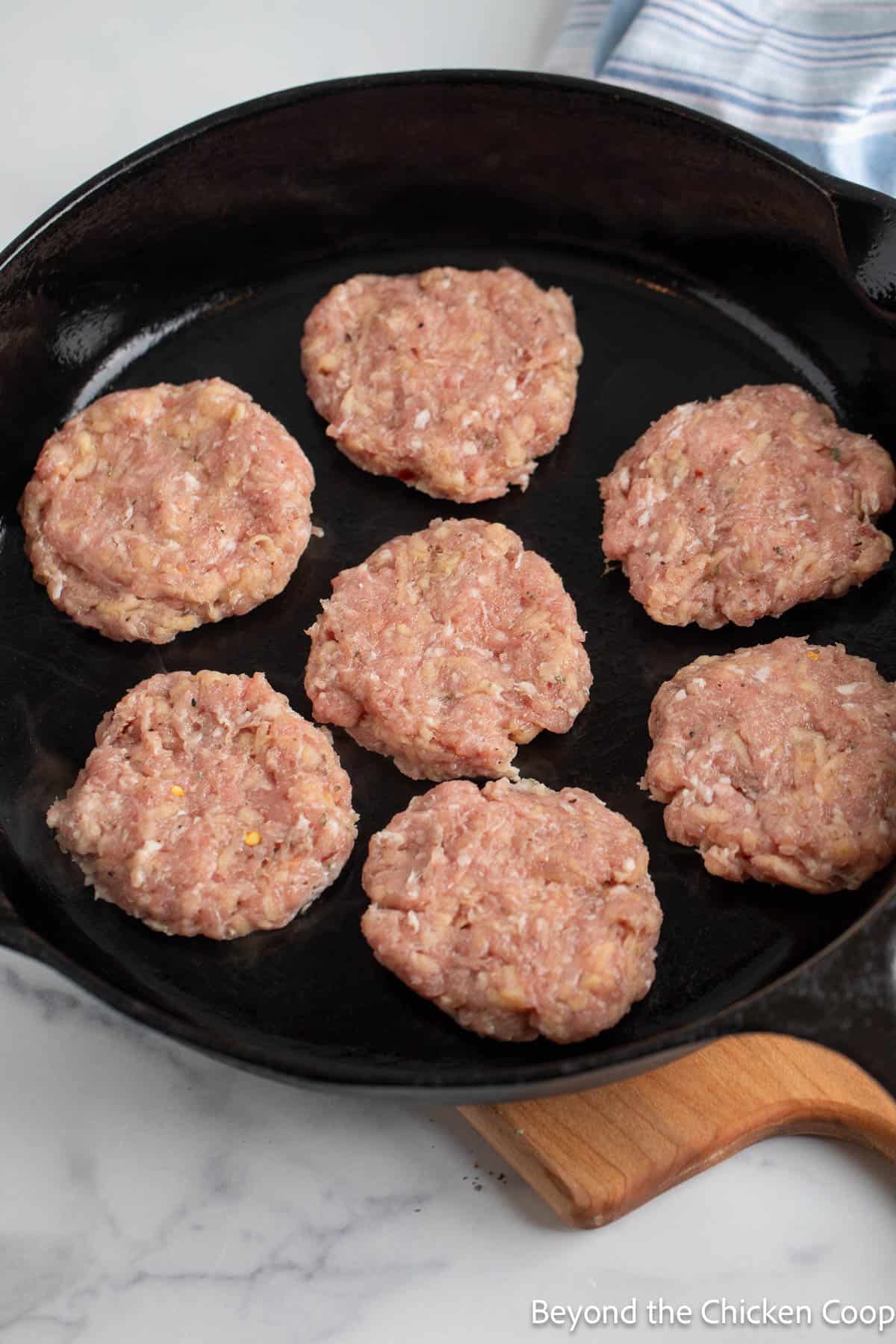 Sausage patties in a cast iron skillets. 