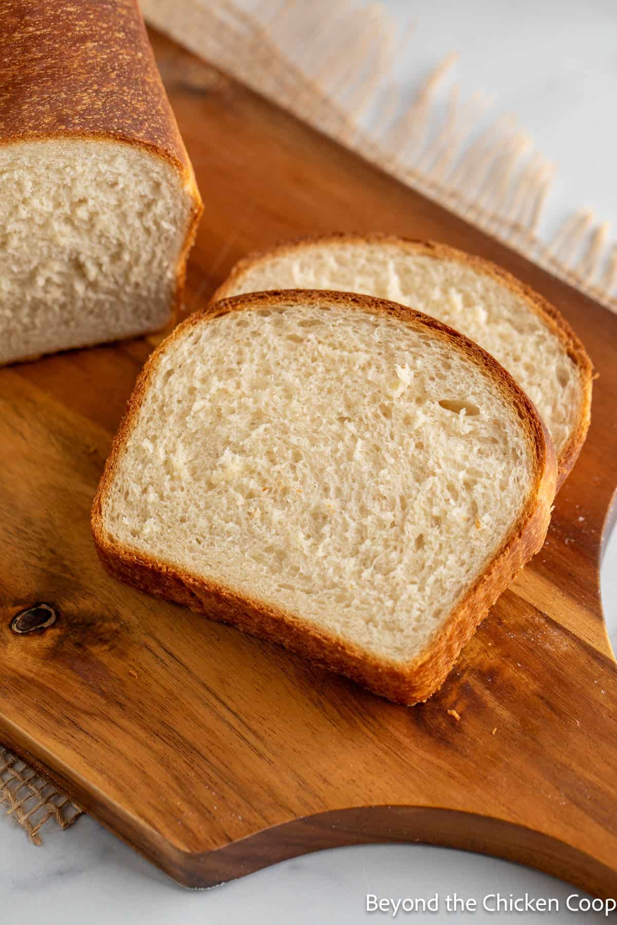 Sliced white bread on a wooden board. 