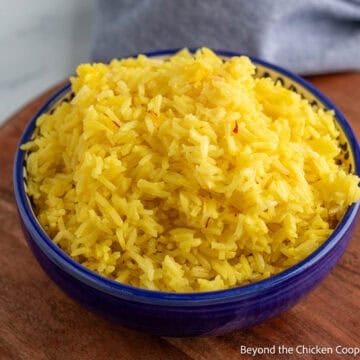 A blue bowl filled with Saffron Rice.