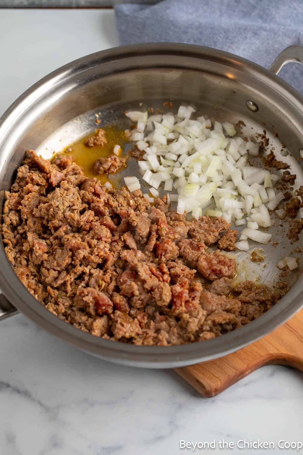 Italian sausage and onions in a large skillet. 