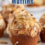 Muffins topped with sliced almonds and sugar on a white plate.