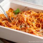 Easy baked spaghetti casserole in a white baking dish.