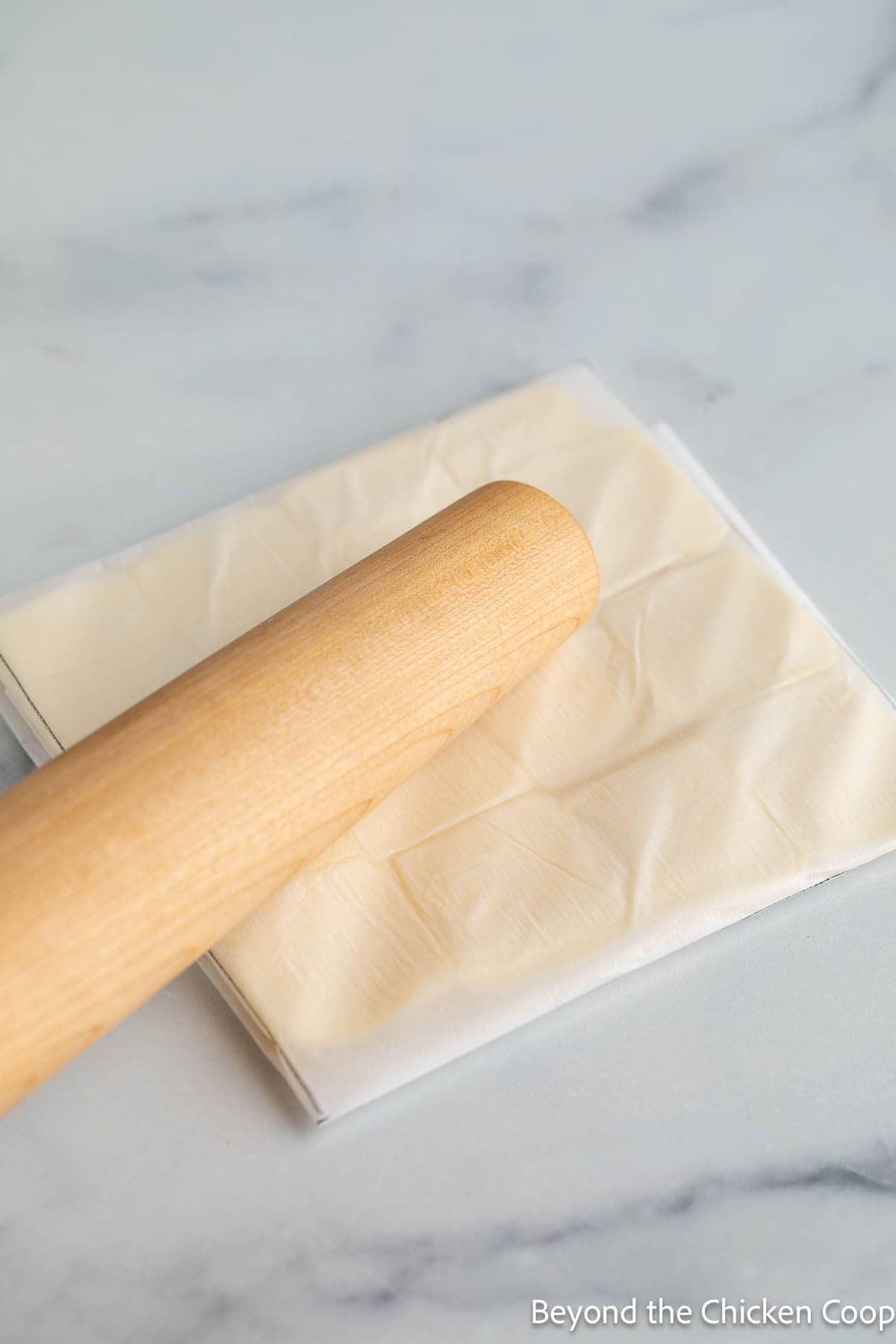 Shaping a butter packet with a rolling pin. 