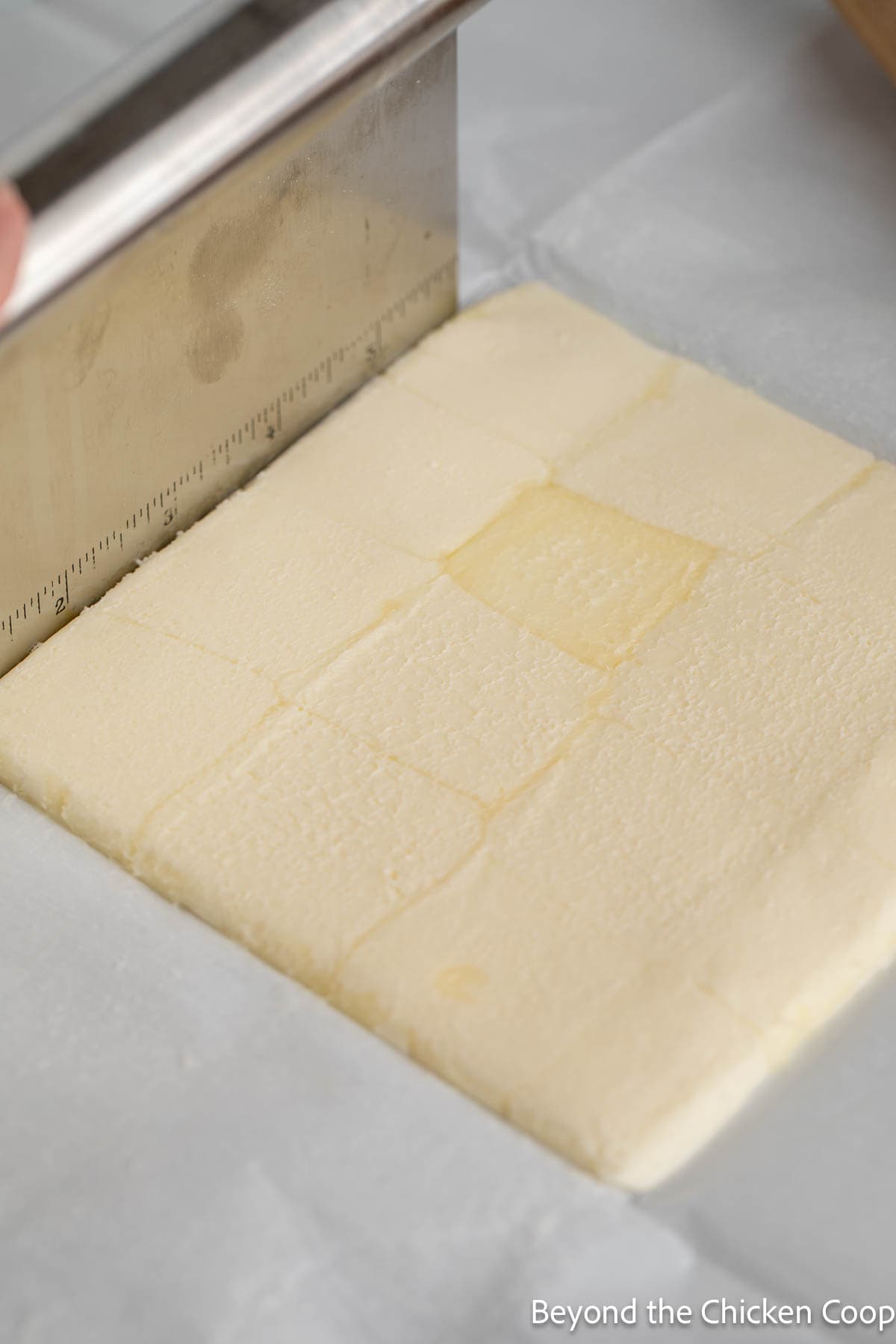Shaping a butter packet with a bench scraper. 