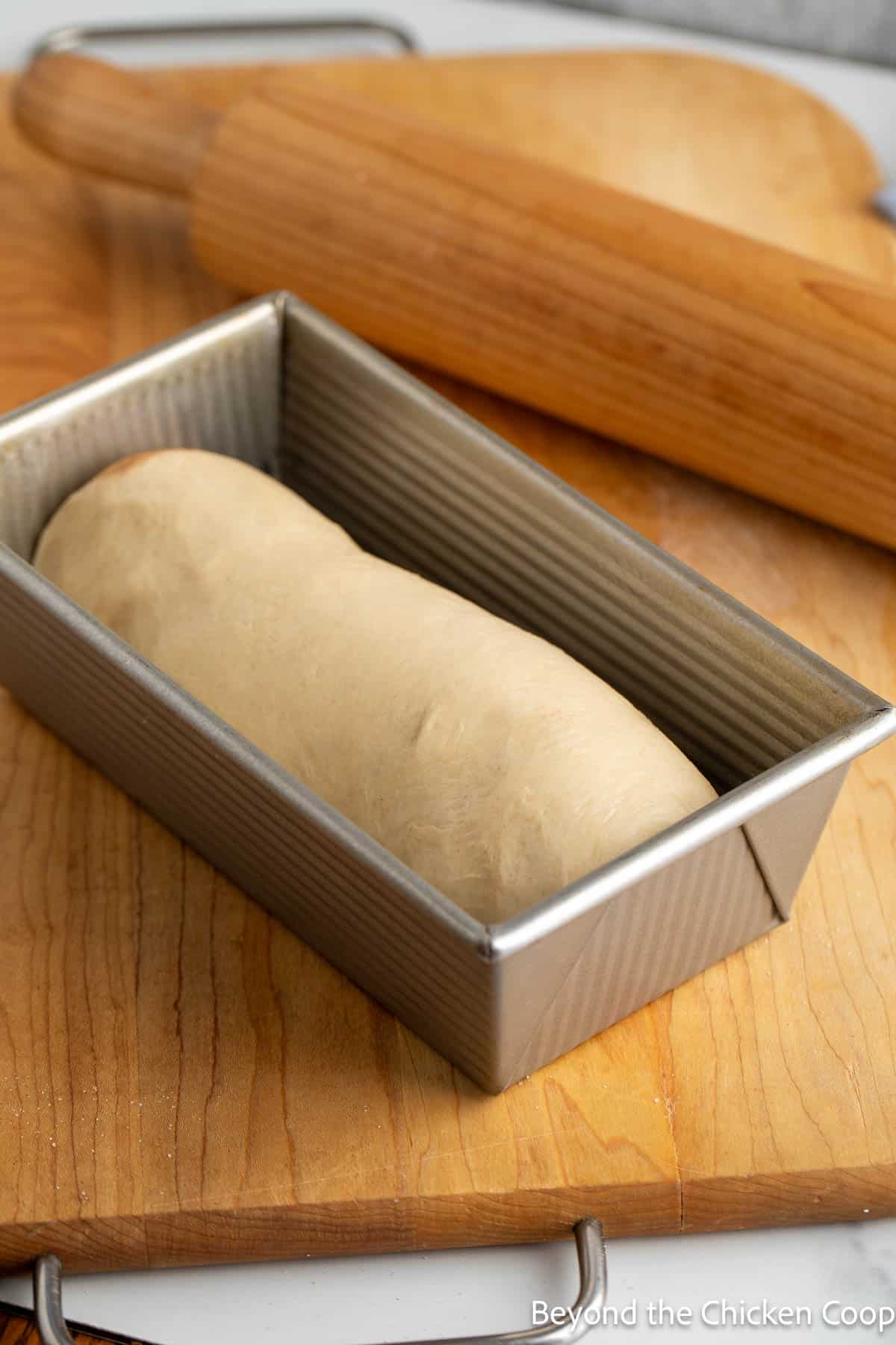 Bread dough in a loaf pan. 