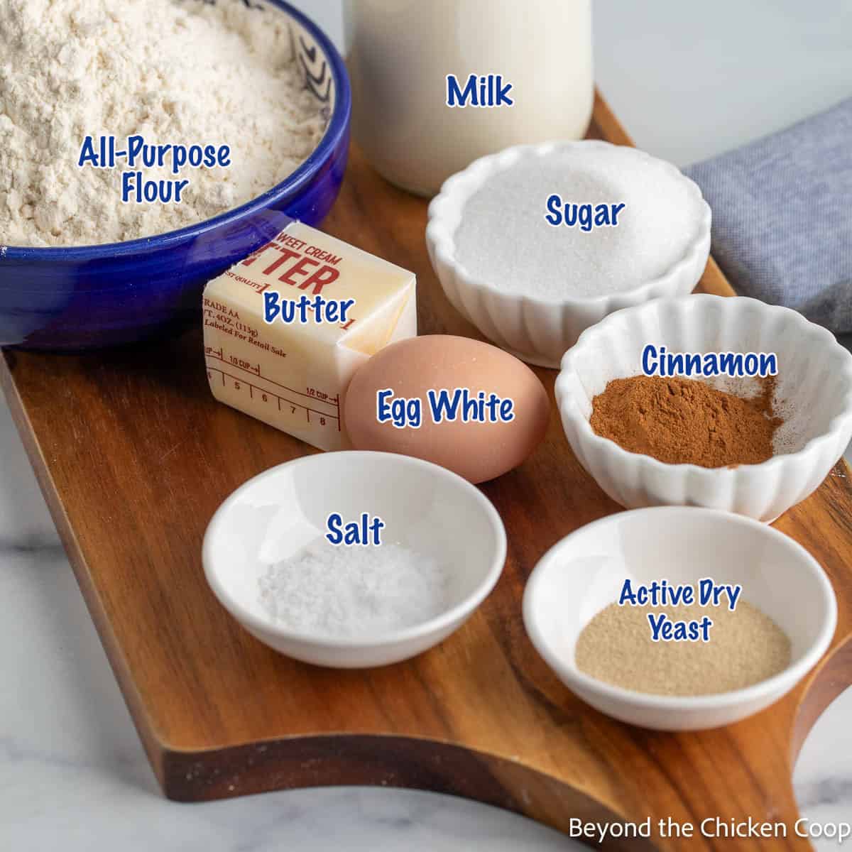 Small bowls filled with ingredients for making cinnamon bread. 