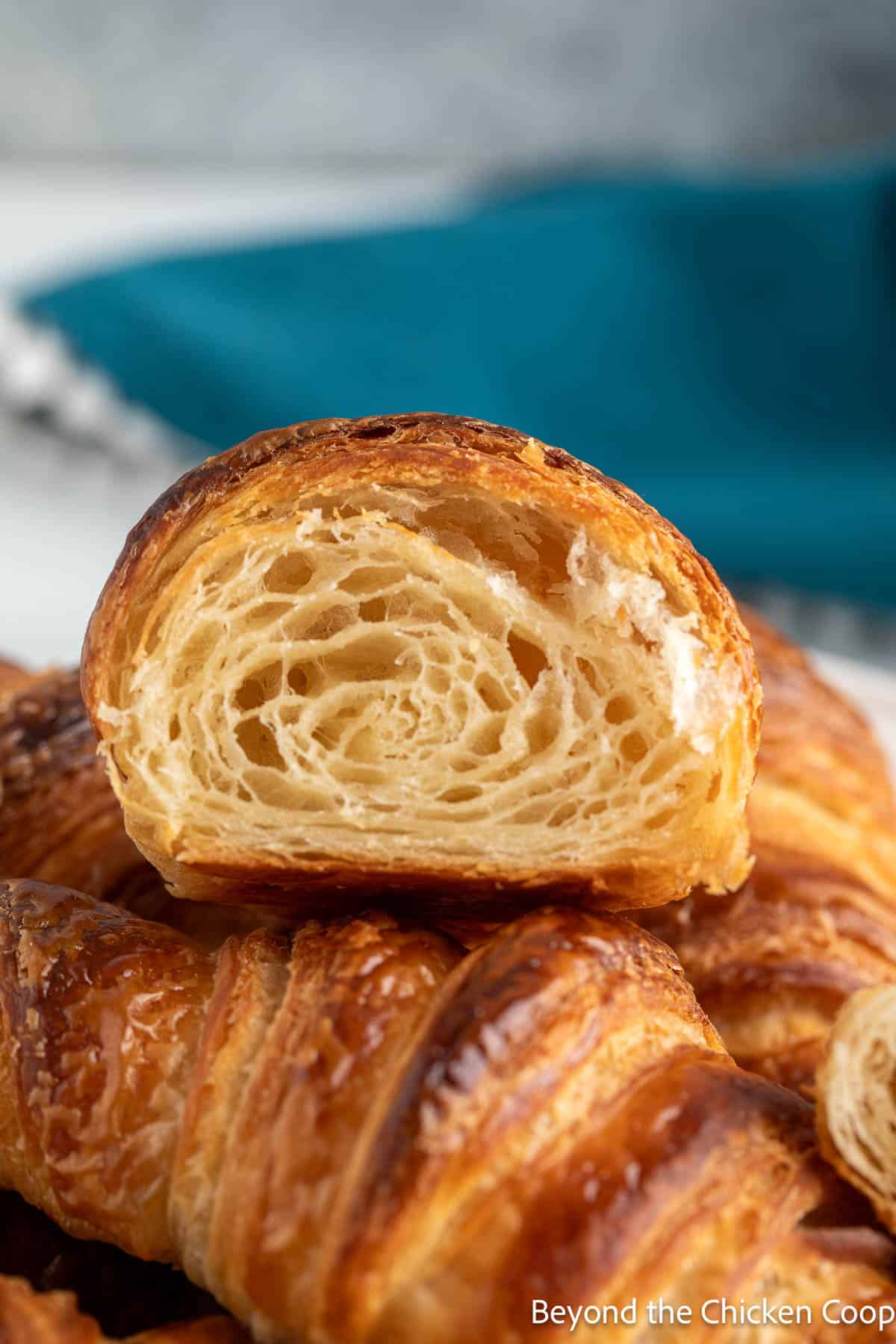A croissant cut in half showing all the layers. 