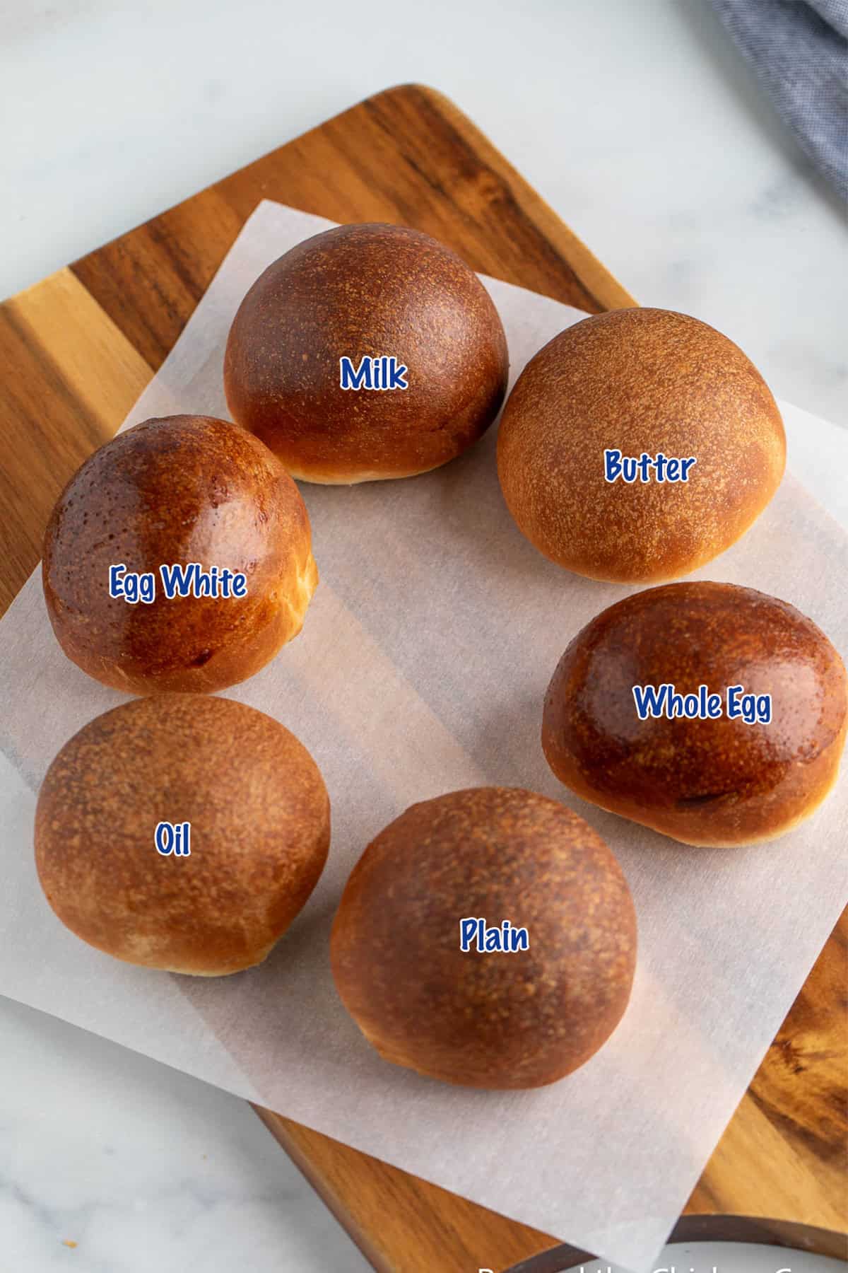 Round dinner rolls finished with different types of glazes. 