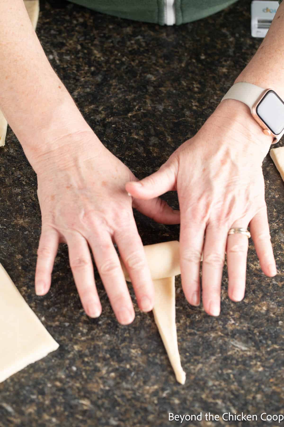 Rolling croissant dough.