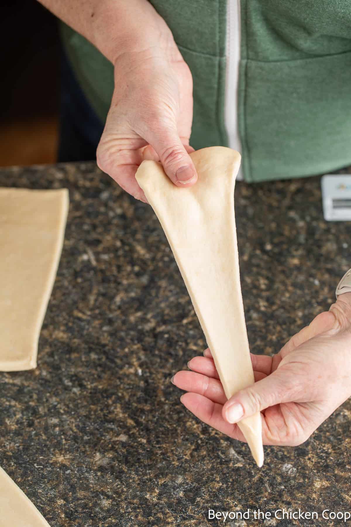 Stretching croissant dough.