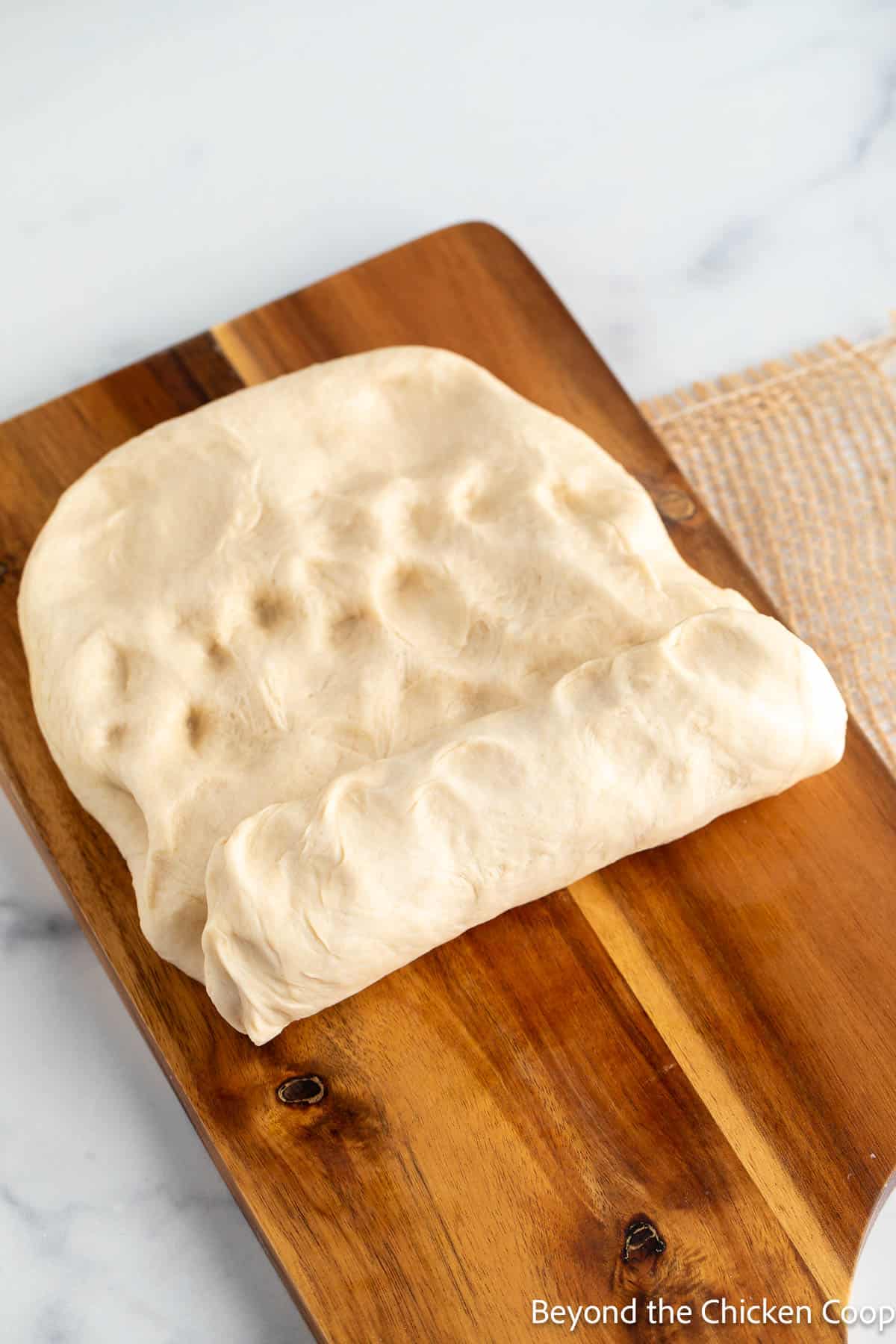 Shaping bread dough into a loaf.