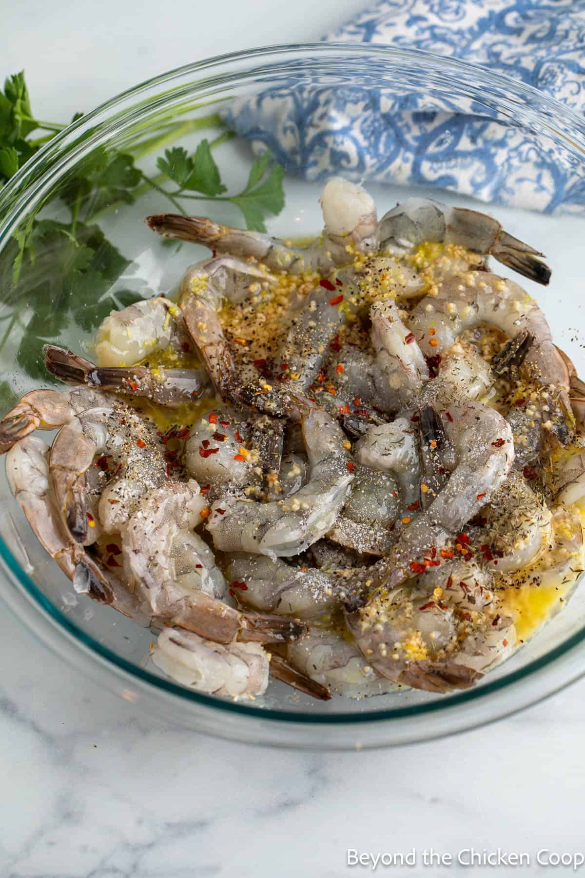 Raw shrimp topped with garlic, seasoning, lemon zest and butter. 