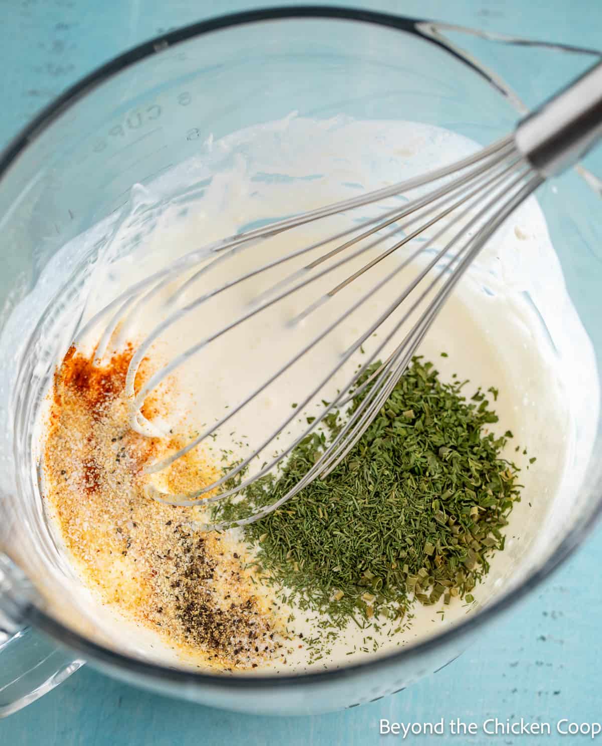 Dried herbs and seasonings in a mixing bowl. 
