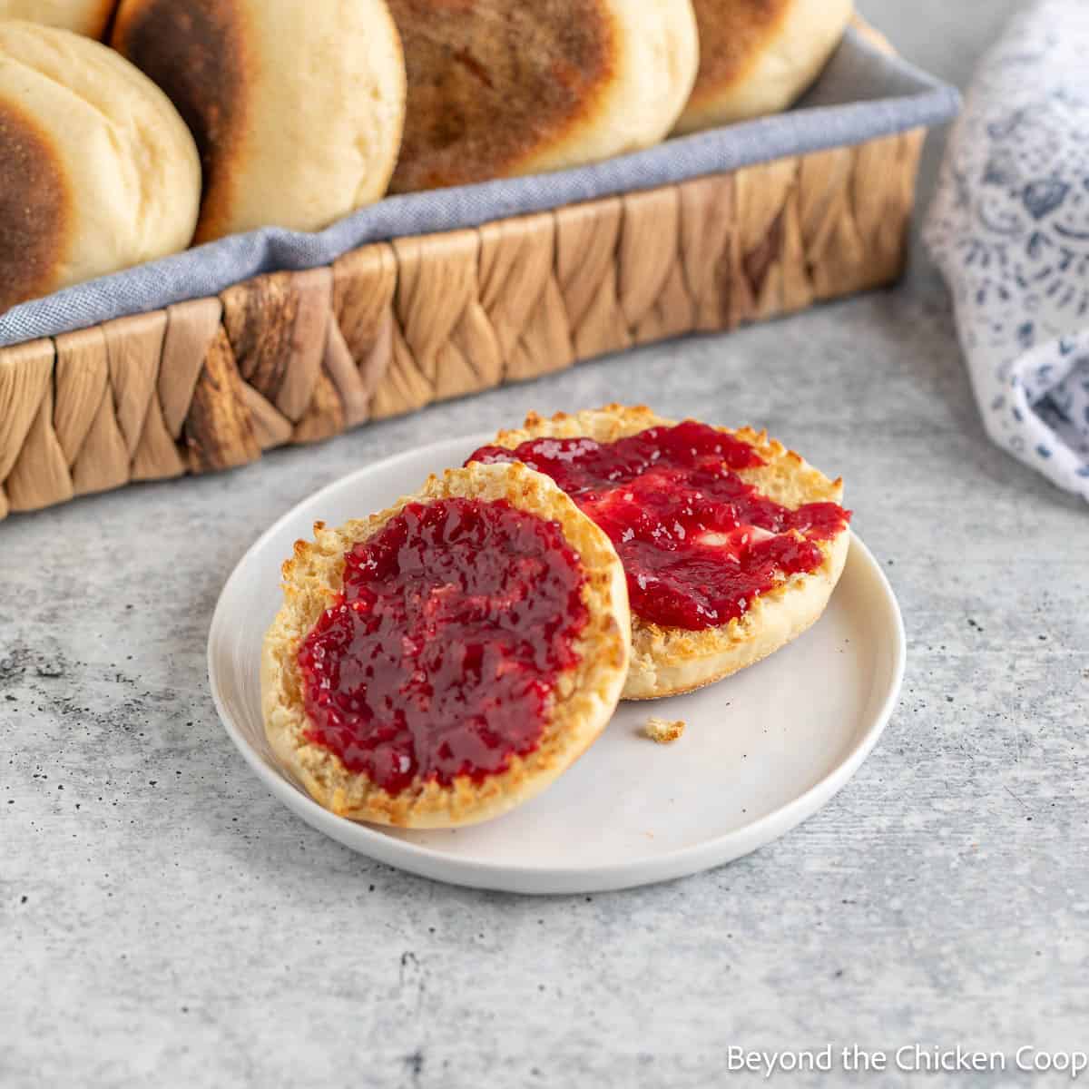 A toasted English muffin topped with raspberry jam. 