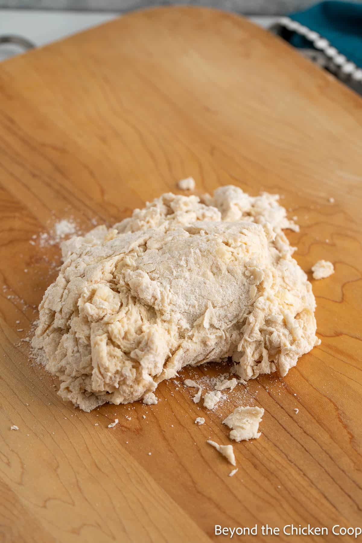 Crumbly dough on a wooden board. 