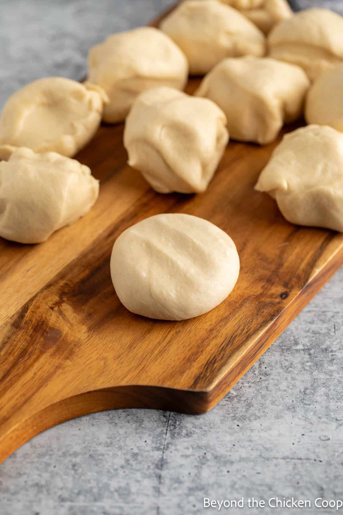 Flattened dough on a wooden board. 