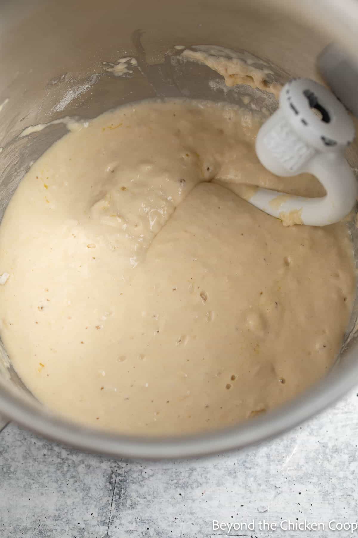 Focaccia dough in a mixing bowl with a dough hook. 