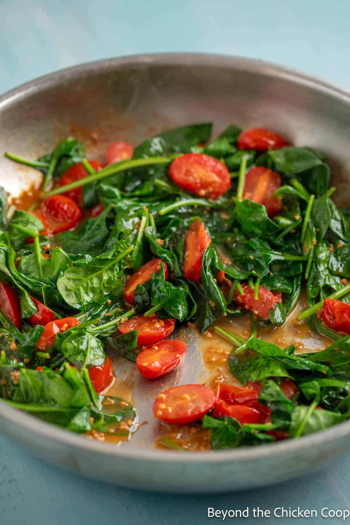 Cooked spinach and cheery tomatoes. 