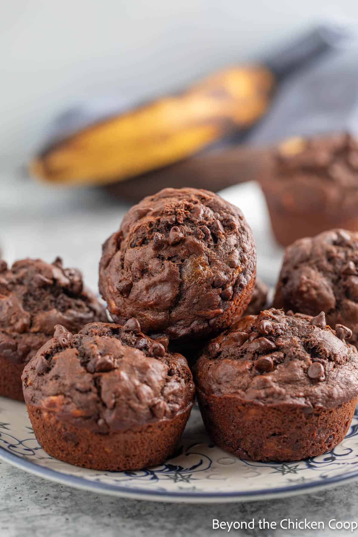 Double chocolate banana muffins on a plate. 