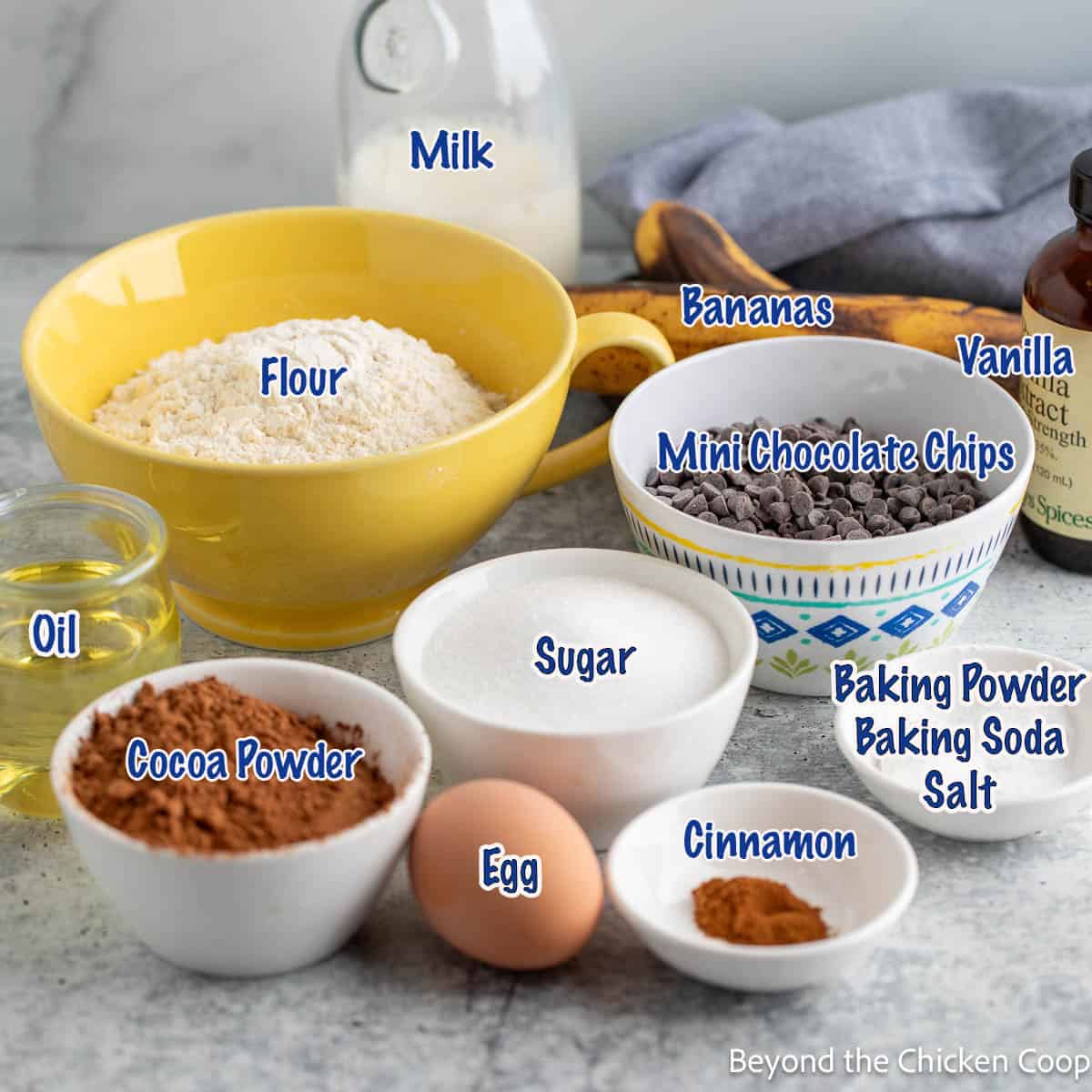 Bowls filled with ingredients for making chocolate muffins. 