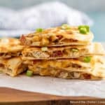 Wedges of Chicken Bacon Ranch Quesadillas on a white piece of parchment paper.