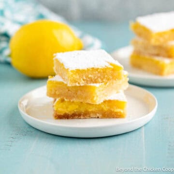 A stack of lemon bars on a small white plate.