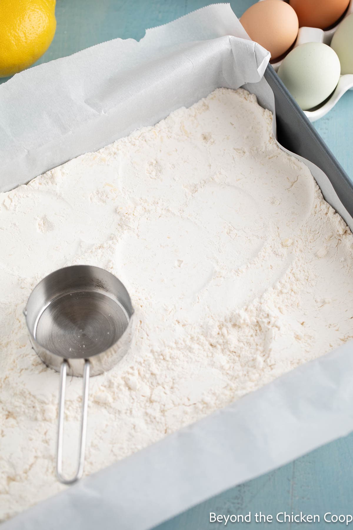 Pressing shortbread crust with a flat bottomed measuring cup. 