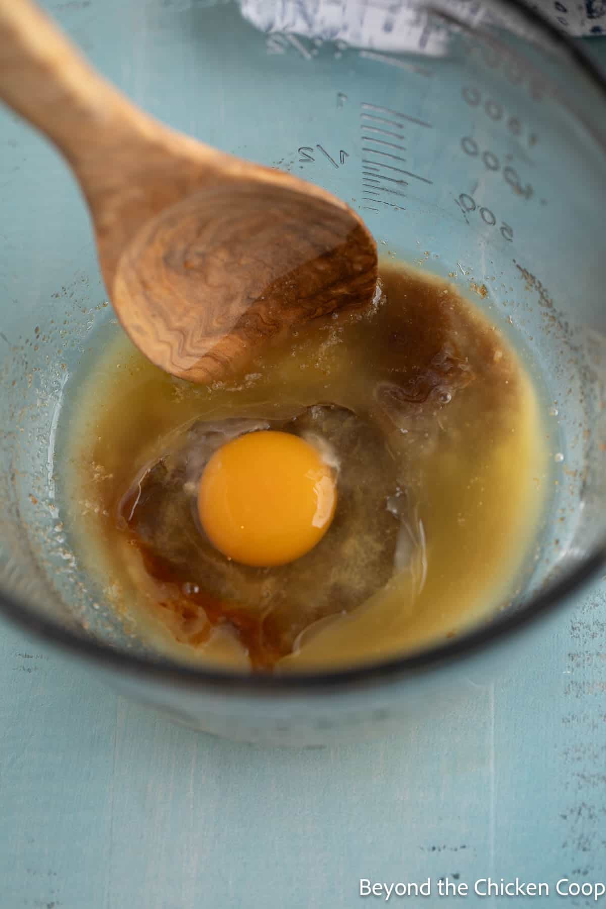 Adding an egg to butter and sugar. 