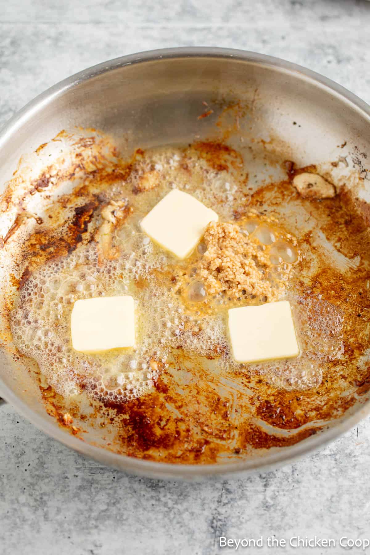 Deglazing a pan with butter and garlic. 