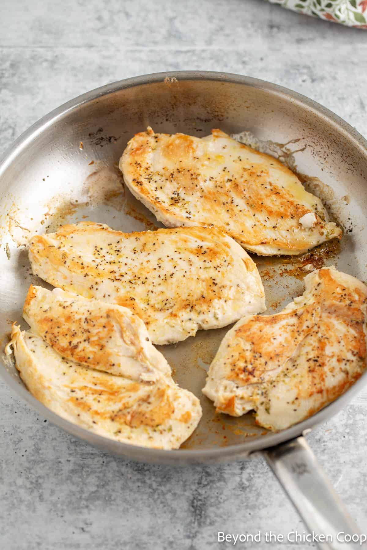 Browned chicken breasts in a skillet. 