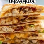 Sliced quesadilla stacked on a white paper.