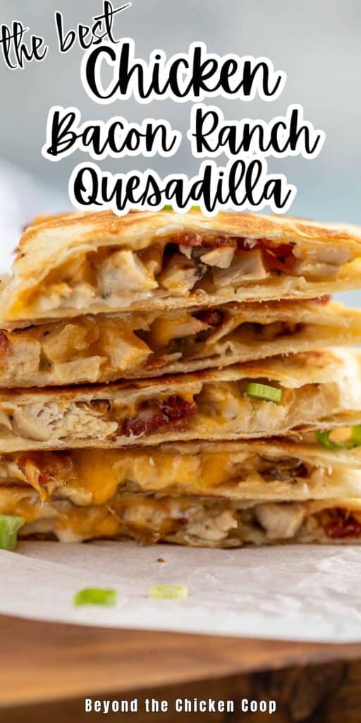 Sliced quesadilla stacked on a white paper.