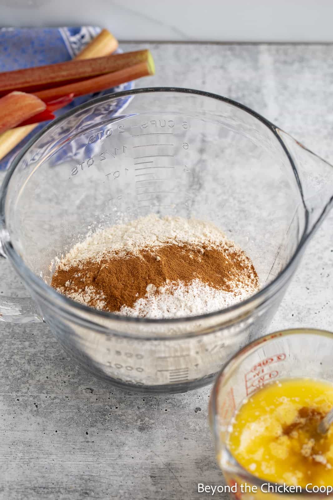 Flour and cinnamon in a glass mixing bowl. 