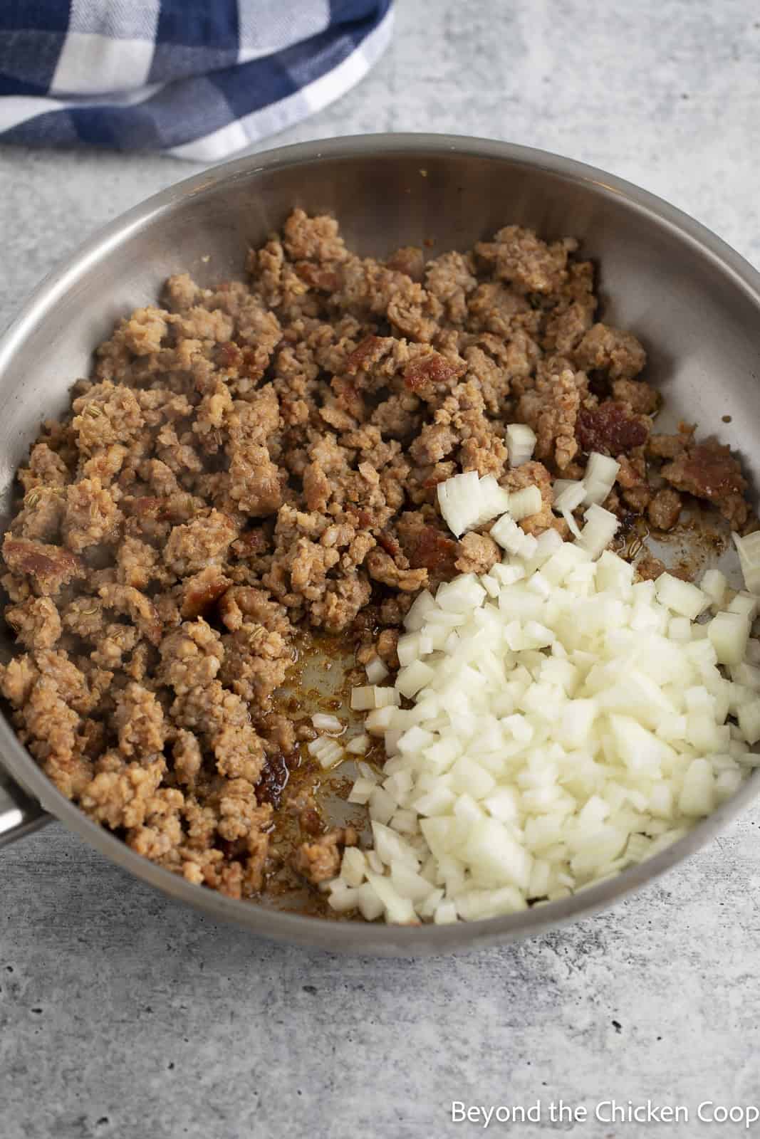 Browning Italian sausage and onions in a skillet. 