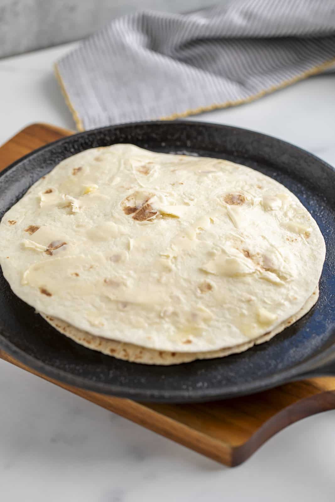 Cooking a quesadilla on a cast iron skillet.