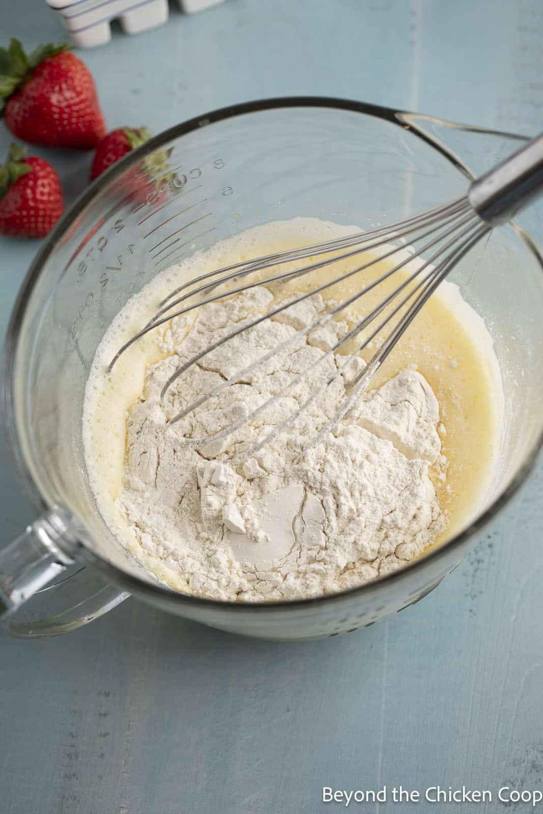 Adding flour to pancake batter. 