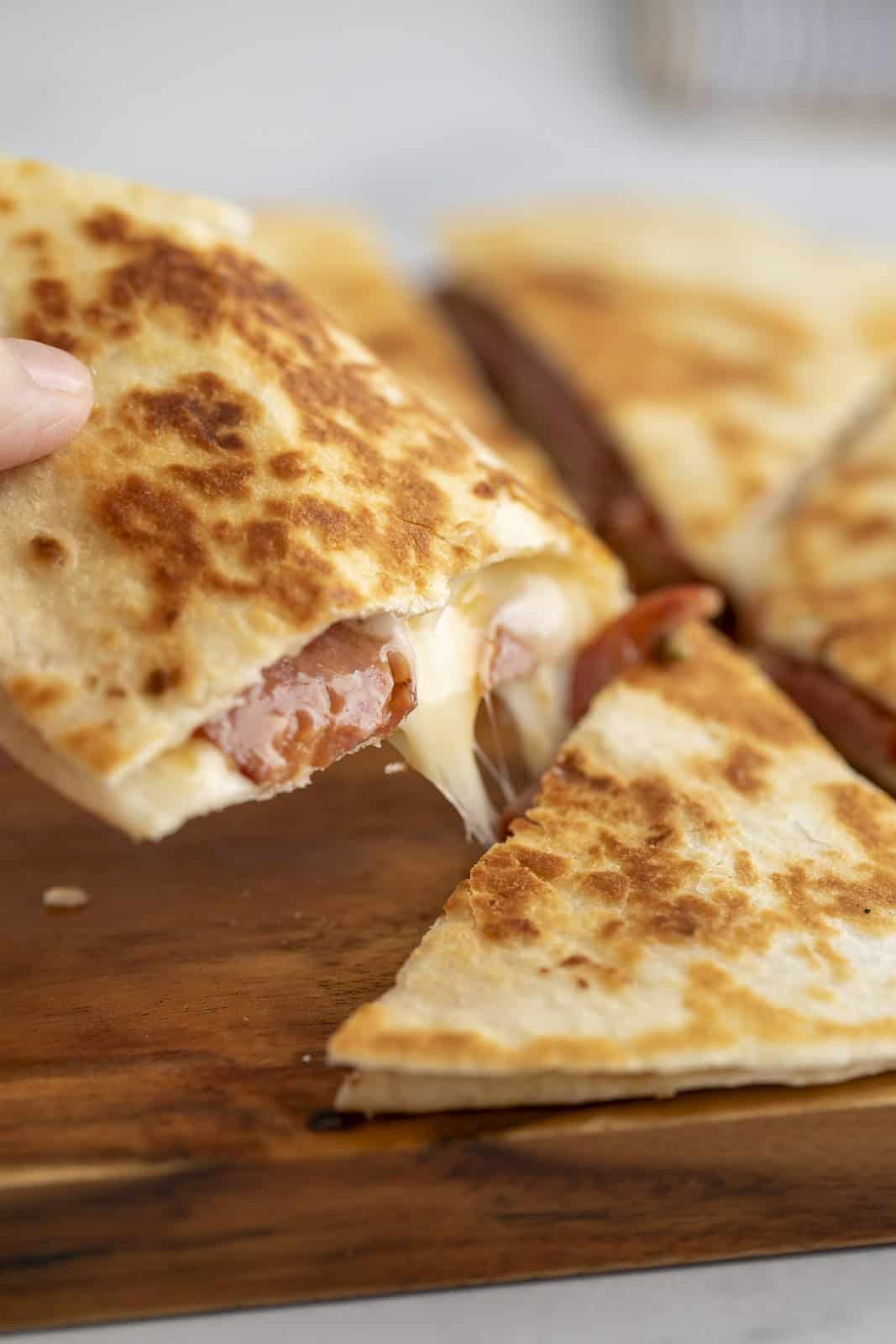 A cheesy pull of a quesadilla wedge.
