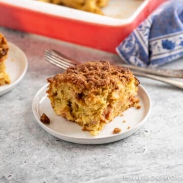 A slice of Rhubarb Coffee Cake on a small white plate.