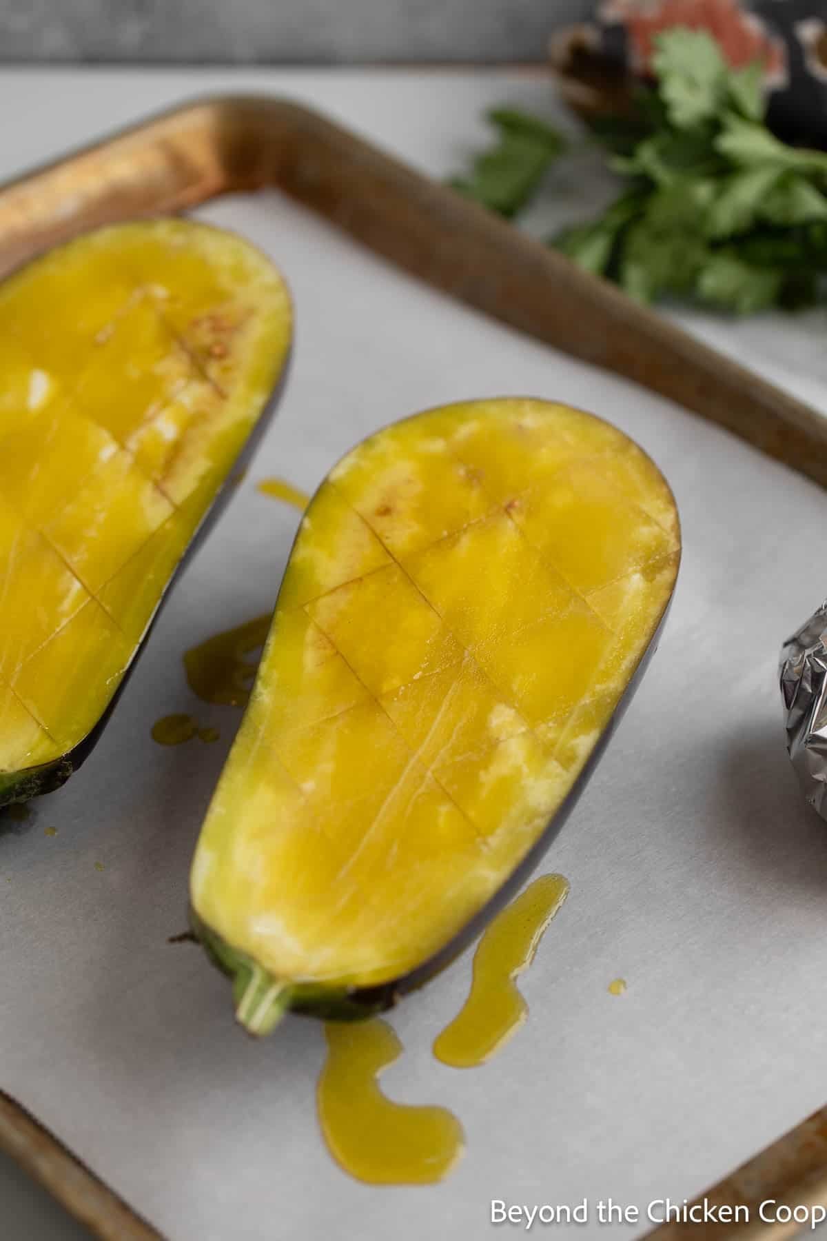 Halved eggplant with olive oil. 