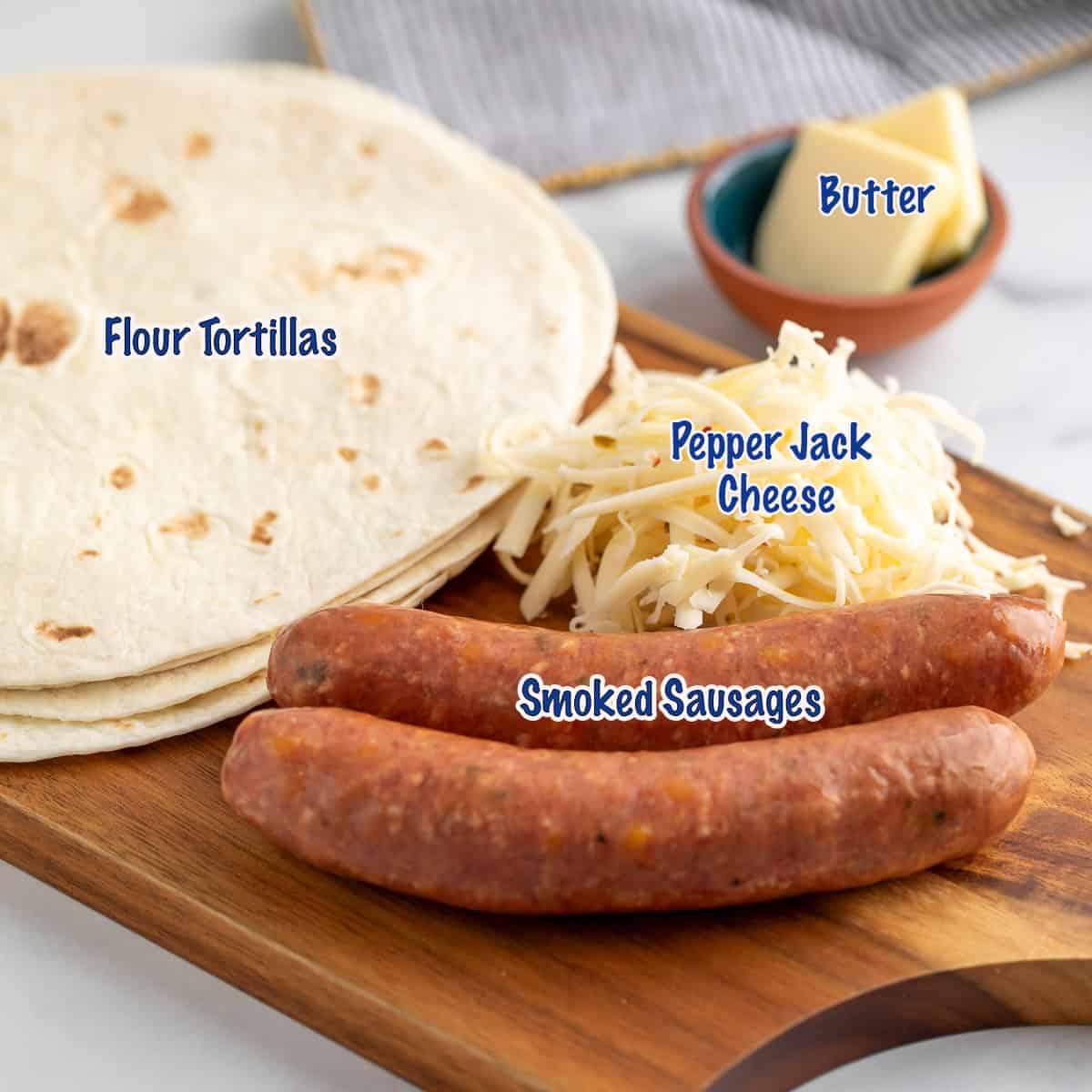 Sausages, shredded cheese, and tortillas on a wooden board. 