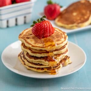Pancakes with strawberries and syrup.