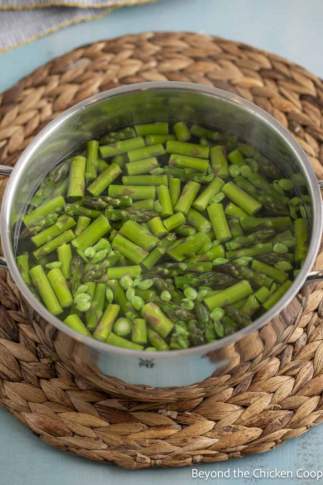 Blanching asparagus and peas together in a pot. 