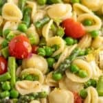 Pasta salad with asparagus, peas, and tomatoes.