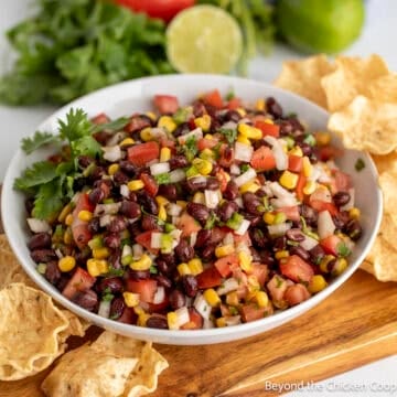 Black Bean Salsa with corn and tomatoes in a white bowl.