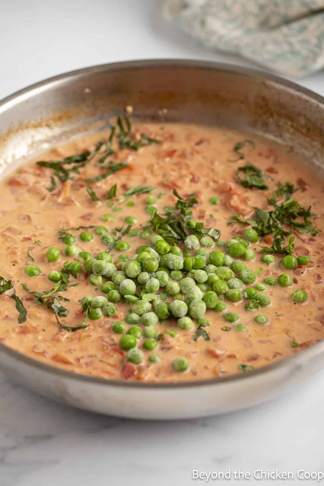 Frozen peas in a creamy tomato sauce. 