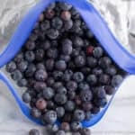 A freeze bag filled with frozen blueberries.