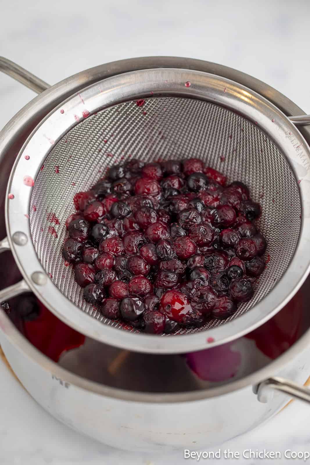 Strained huckleberries in a colander. 